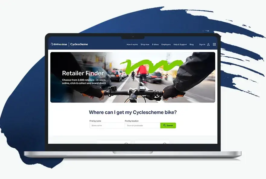 Laptop displaying the Cyclescheme Retailer Finder page with a search form for finding bike retailers.